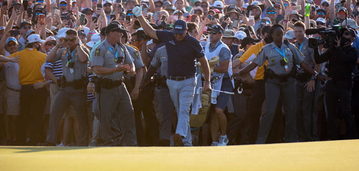 Phil Mickelson emerges from the swarm of fans onto the final green | Photo: Golf Channel